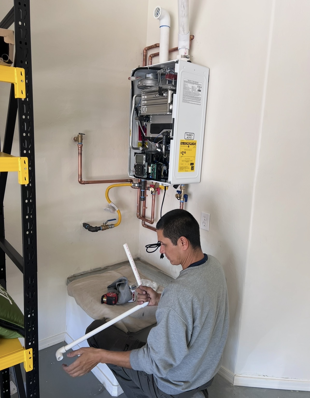 Technician servicing a tankless water heater install